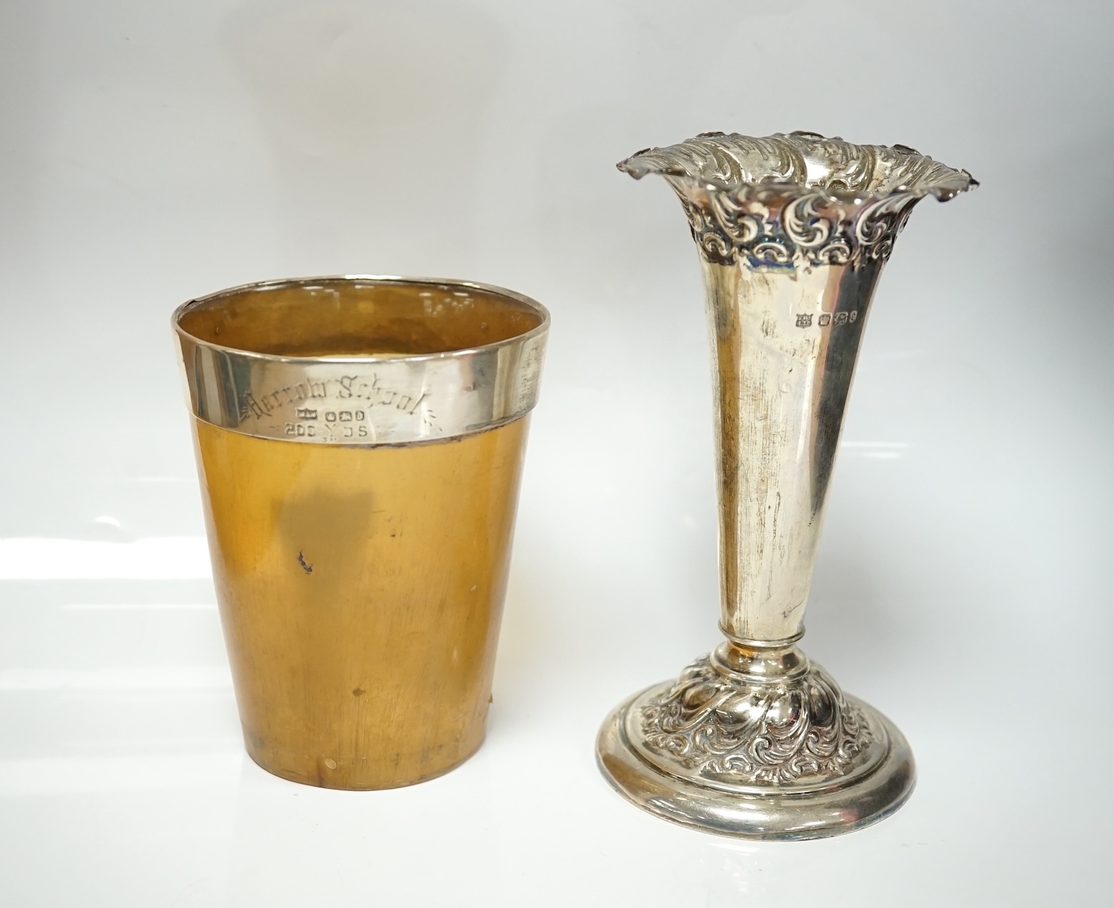 A late Victorian silver mounted horn beaker, Mappin & Webb, Sheffield, 1896, 10.6cm, a.f. a similar repousse silver posy vase and two silver mustard pots. Condition - poor to fair